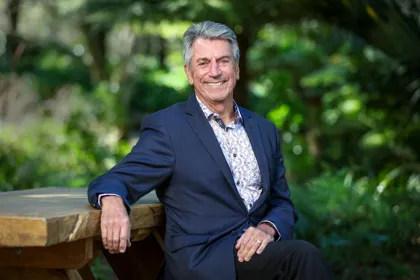 Chief Ombudsman Peter Boshier sitting down in a garden